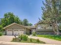 Charming home featuring a lush front yard and a convenient two-car garage at 5254 W Oberlin Dr, Denver, CO 80235