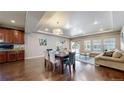 Elegant dining area flowing into the living room, creating a perfect space for gatherings and relaxation at 18009 E 47Th Pl, Denver, CO 80249
