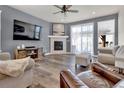 Cozy living room with a stone fireplace, plush seating, and ample natural light at 8248 S Yantley Ct, Aurora, CO 80016