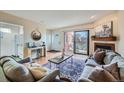 Bright living room with fireplace, stylish decor, and sliding glass doors to a cozy balcony at 3050 W 32Nd Ave # 202C, Denver, CO 80211