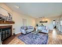 Inviting living room with a brick fireplace and a stylish area rug at 3050 W 32Nd Ave # 202C, Denver, CO 80211