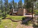 Sprawling home with manicured landscaping, retaining walls, and an attached two-car garage at 6100 Apache Dr, Larkspur, CO 80118