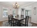 Formal dining room features a chandelier, large windows, and an adjacent doorway at 19653 E Ida Dr, Aurora, CO 80015