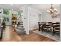 Elegant dining room showcasing hardwood floors, chandelier, and seamless transition to the living area at 19653 E Ida Dr, Aurora, CO 80015