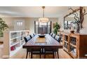 Inviting dining room with long table, stylish decor, and adjacent shelving for display at 1166 Krameria St, Denver, CO 80220