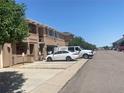 Exterior view of townhomes in a row with reserved parking in front under a clear blue sky at 9300 E Florida Ave # 608, Denver, CO 80247