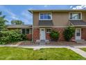 Charming townhome exterior with brick accents and well-maintained lawn at 2232 Coronado Pkwy # B, Denver, CO 80229