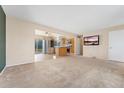 Open-concept living space with seamless transition to a kitchen featuring stainless steel appliances at 2916 S Jasper St, Aurora, CO 80013