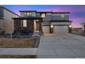 Charming two-story home featuring a stone facade, three-car garage, and a well-manicured front yard at 12663 Buffington Trl, Parker, CO 80134