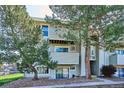 Residential building featuring balconies, green landscaping, and unit entrances at 10150 E Virginia Ave # 7-204, Denver, CO 80247
