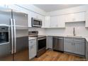 Modern kitchen with stainless steel appliances and white cabinets at 1597 S Salem Cir, Aurora, CO 80012