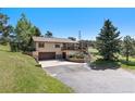 Inviting home with a two-car garage and front yard with mature trees at 713 Aspen Rd, Golden, CO 80401