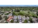 Beautiful aerial view of a neighborhood with lush greenery, showcasing a park and the surrounding homes at 220 Glencoe St, Denver, CO 80220