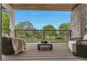 Relaxing outdoor balcony with comfortable seating overlooking a picturesque green landscape on a sunny day at 220 Glencoe St, Denver, CO 80220