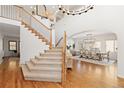 Elegant foyer with hardwood floors, a staircase, and a chandelier above the dining room at 2832 Danbury Ave, Highlands Ranch, CO 80126
