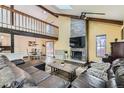 Spacious living room featuring vaulted ceilings, a brick fireplace, and an open floor plan at 6225 E Mississippi Ave, Denver, CO 80224