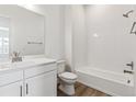 Clean bathroom, white vanity, shower and bathtub, and tiled flooring at 8845 Yellowcress St, Littleton, CO 80125