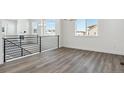 Living room with gray vinyl plank flooring, modern staircase and a view at 8845 Yellowcress St, Littleton, CO 80125