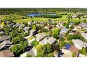 Aerial view of a neighborhood near Broadlands Golf Course with lush landscaping and a serene lake at 13971 Star Creek Dr, Broomfield, CO 80023