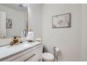 Stylish half bathroom featuring elegant fixtures and a modern vanity with attractive wall art at 1179 S Fultondale Cir, Aurora, CO 80018