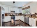 Modern kitchen with stainless steel appliances, granite countertops, and ample cabinet space at 1179 S Fultondale Cir, Aurora, CO 80018