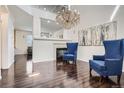 Bright, open living space with hardwood floors, a fireplace, and a stunning chandelier at 1179 S Fultondale Cir, Aurora, CO 80018