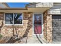Close up of the front door with brick facade and landscaping details at 4655 Independence St # 3, Wheat Ridge, CO 80033