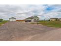 A beautiful house with a detached garage and a driveway at 16516 Fairbanks Rd, Platteville, CO 80651