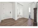 Inviting entryway with beautiful wood-look floors and a view of a bright powder room at 25214 E Warren Pl, Aurora, CO 80018
