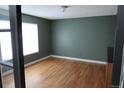 Cozy bedroom with hardwood floors and large bright window at 12381 E Vassar Dr, Aurora, CO 80014