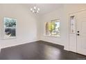 Bright dining room featuring wood floors and natural light from multiple windows at 19033 E 22Nd Cir, Aurora, CO 80011