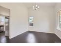 Bright dining room featuring wood floors, modern chandelier, and natural light at 19033 E 22Nd Cir, Aurora, CO 80011