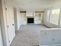 Spacious living room featuring a cozy fireplace, built-in shelving, and ample natural light at 19033 E 22Nd Cir, Aurora, CO 80011