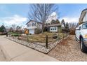 Well-maintained home with charming wood fence, landscaping, and a spacious driveway at 3411 S Olathe Way, Aurora, CO 80013