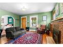Bright living room with fireplace, wood floors, comfortable sofa, and natural light at 4321 Winona Ct, Denver, CO 80212