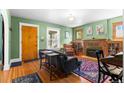 Inviting living room featuring hardwood floors, a brick fireplace, and large windows at 4321 Winona Ct, Denver, CO 80212