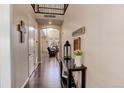Welcoming entryway with hardwood floors and decorative console table with flowers and a lantern at 2454 Ambience Ln, Castle Rock, CO 80109