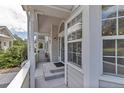 Inviting front porch with columns, a glass door, and large windows creating a bright entryway at 4013 S Carson St # C, Aurora, CO 80014