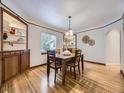 Inviting dining room with hardwood floors, built-in shelving, and a large window creating a warm atmosphere at 2260 Leyden St, Denver, CO 80207