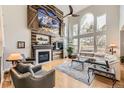 Spacious living room with high ceilings, large windows, fireplace, and modern decor at 1312 Pine View Rd, Golden, CO 80403