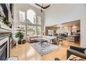 Open concept living space with vaulted ceilings, fireplace, and seamless flow to dining area at 1312 Pine View Rd, Golden, CO 80403
