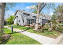 Lovely gray home with a landscaped yard, patio area, and an attached two-car garage at 7126 Cedarwood Cir, Boulder, CO 80301