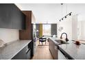 Open-concept kitchen with stainless steel appliances and a view into the living room at 5780 W 92 Ave, Westminster, CO 80031