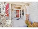 Inviting front porch with decorative brick column, stylish front door, and trimmed shrubbery at 8743 Fairview Oaks Ln, Lone Tree, CO 80124