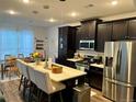 Stylish kitchen featuring an island with bar seating and stainless steel appliances at 2010 S Holly St # 3, Denver, CO 80222