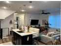 Open-concept living space with kitchen island and modern furnishings at 2010 S Holly St # 3, Denver, CO 80222
