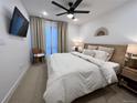 Serene main bedroom featuring a ceiling fan, TV, and large window at 2010 S Holly St # 3, Denver, CO 80222