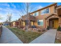 Exterior view of a two-story townhome with a walkway and landscaping at 8524 Gold Peak Dr # B, Highlands Ranch, CO 80130