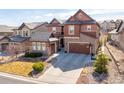 Beautiful two-story home with stone accents, attached garage and landscaped front yard at 1128 Starglow Pl, Highlands Ranch, CO 80126