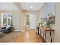 Inviting foyer with hardwood floors and a console table with stylish decor at 4821 Bluegate Dr, Highlands Ranch, CO 80130